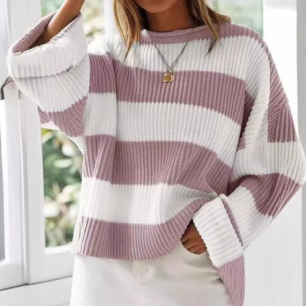 Women's striped loose sweater with bell sleeves and crocheted flower decoration.