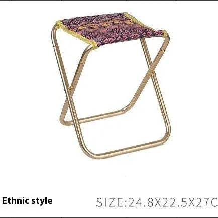 Black ethnic style aluminium alloy folding stool set up on grass.