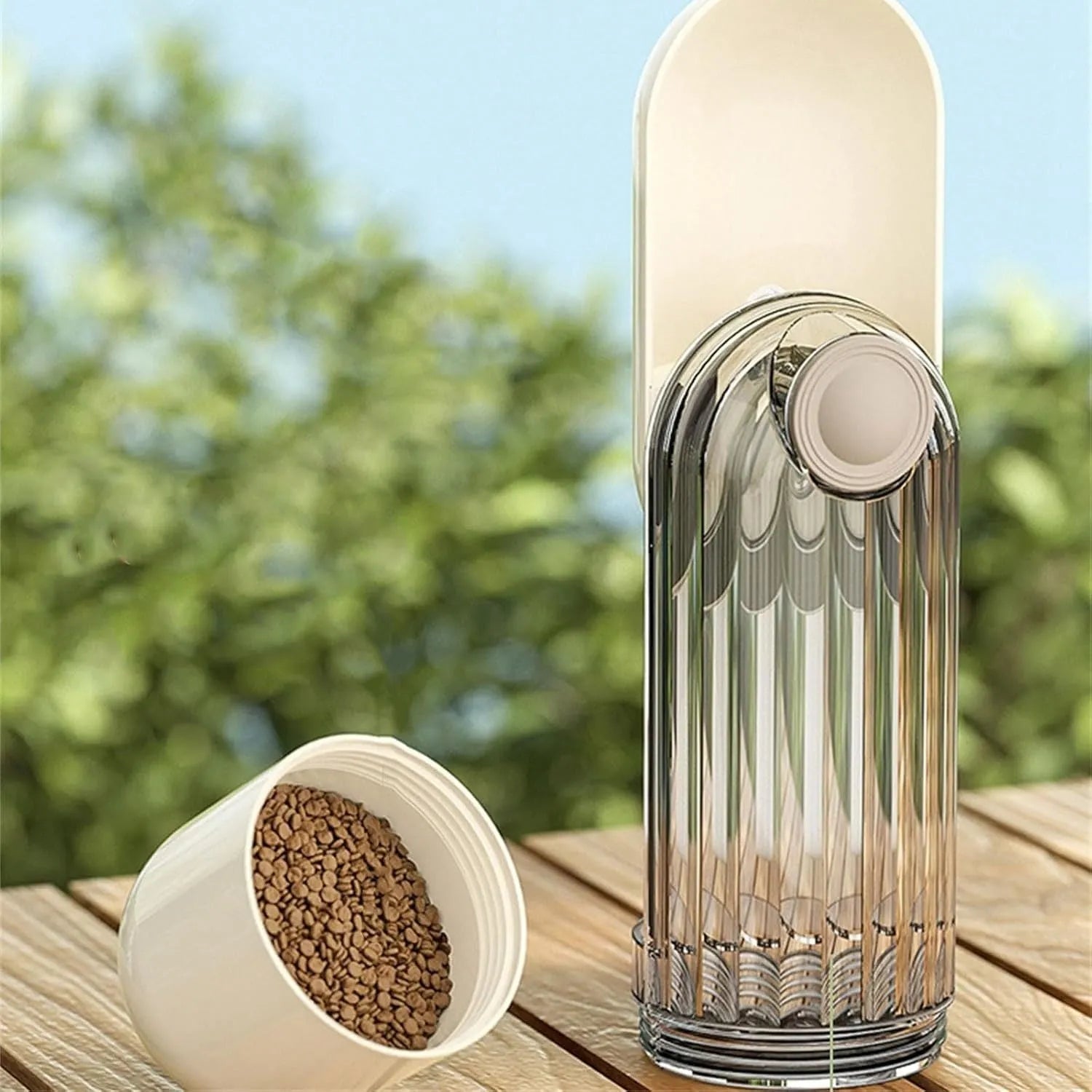 Beige and green portable dog water bottle with food dispenser, shown folded and unfolded.