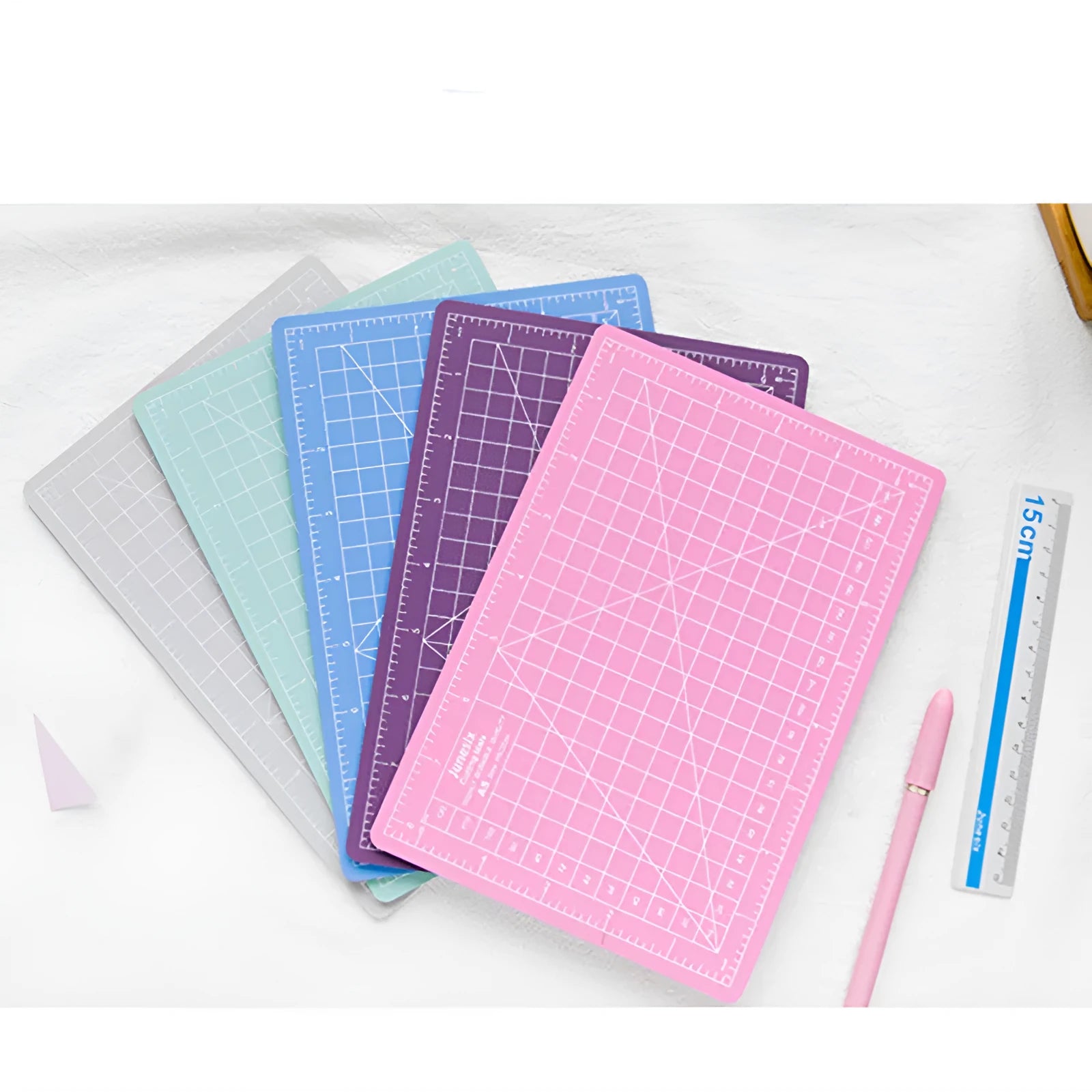 Art pen knife cutting board set with backing board, ruler, sharpener and blade in craft workspace