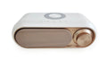 Space Grey wireless charging Bluetooth alarm clock speaker with LED display on a bedside table.