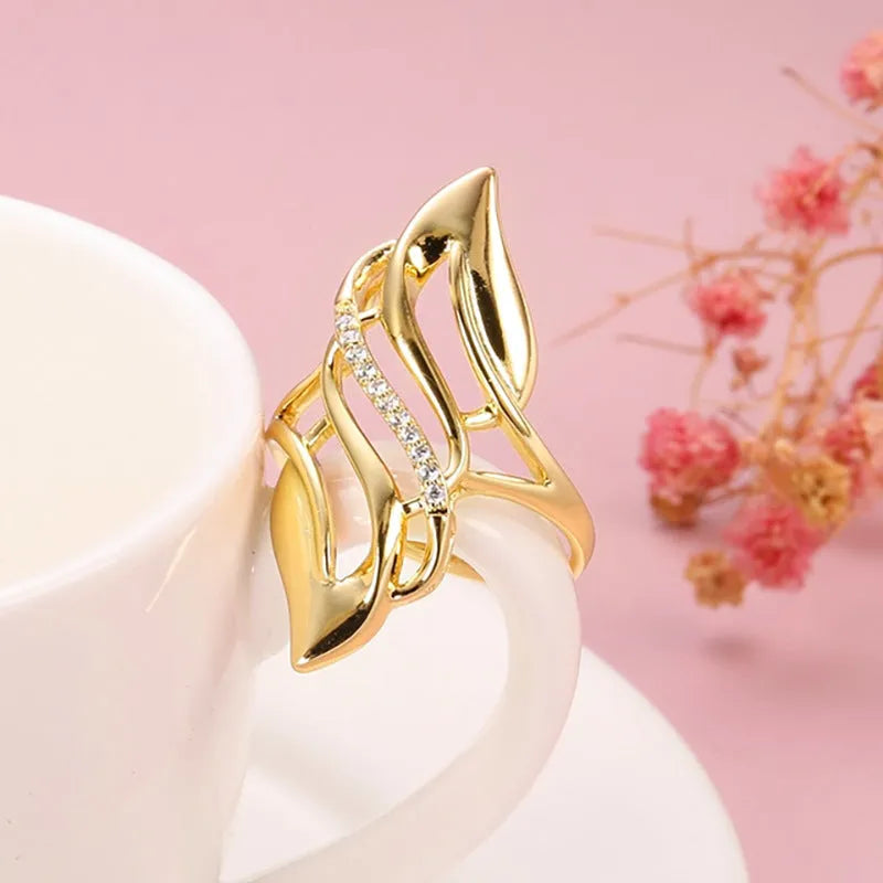 Women's copper ring with exaggerated curved design and zircon stone accents in gold colour