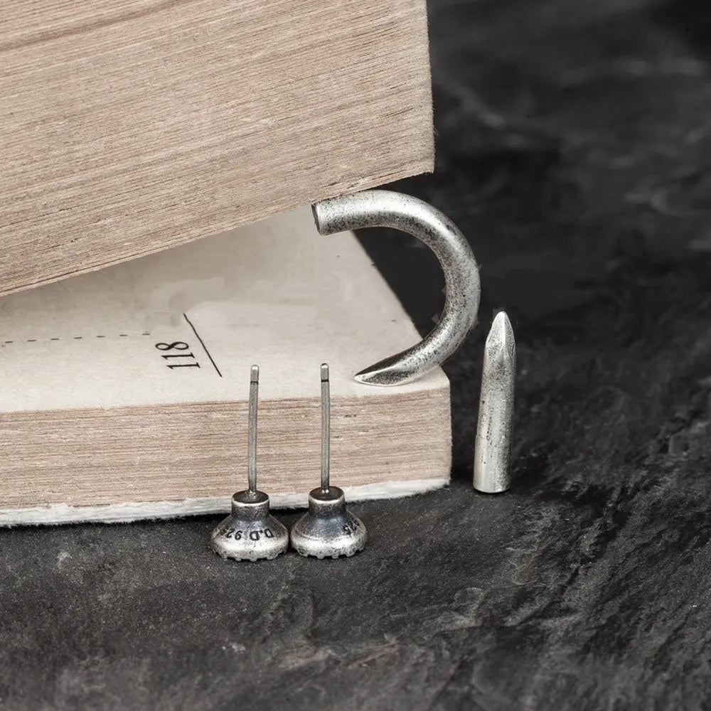 Sterling silver nail stud earrings in straight and curved punk designs