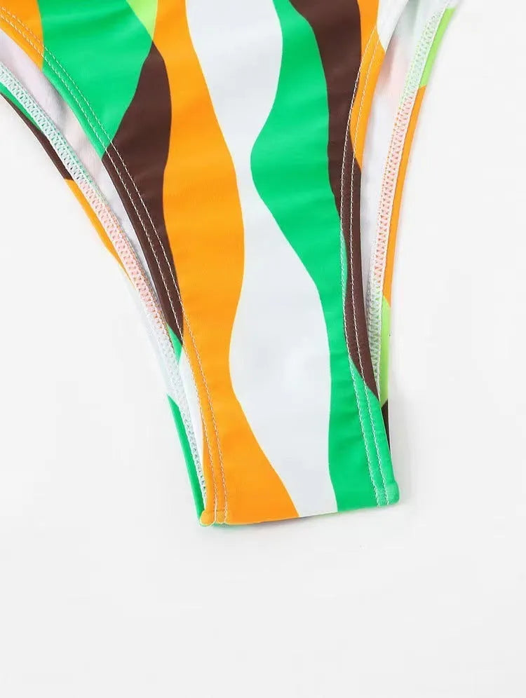 Women's yellow green three-piece swimsuit set with bikini top, briefs, and a printed beach skirt.