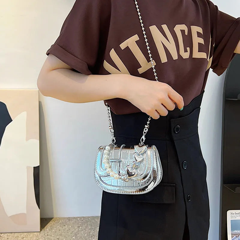 PU women's crossbody bag with laser pearl finish in silver colour showing horizontal square shape and shoulder strap