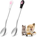 White and black stainless steel pet food spoons with cat paw design and silicone handles