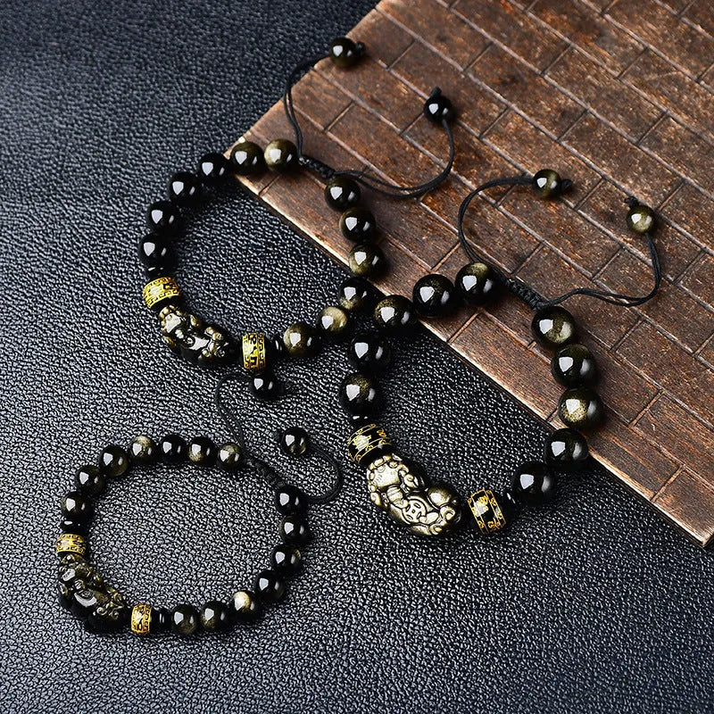 Original hand-woven golden obsidian Pi Xiu bracelet showing bead detail and Chinese style design