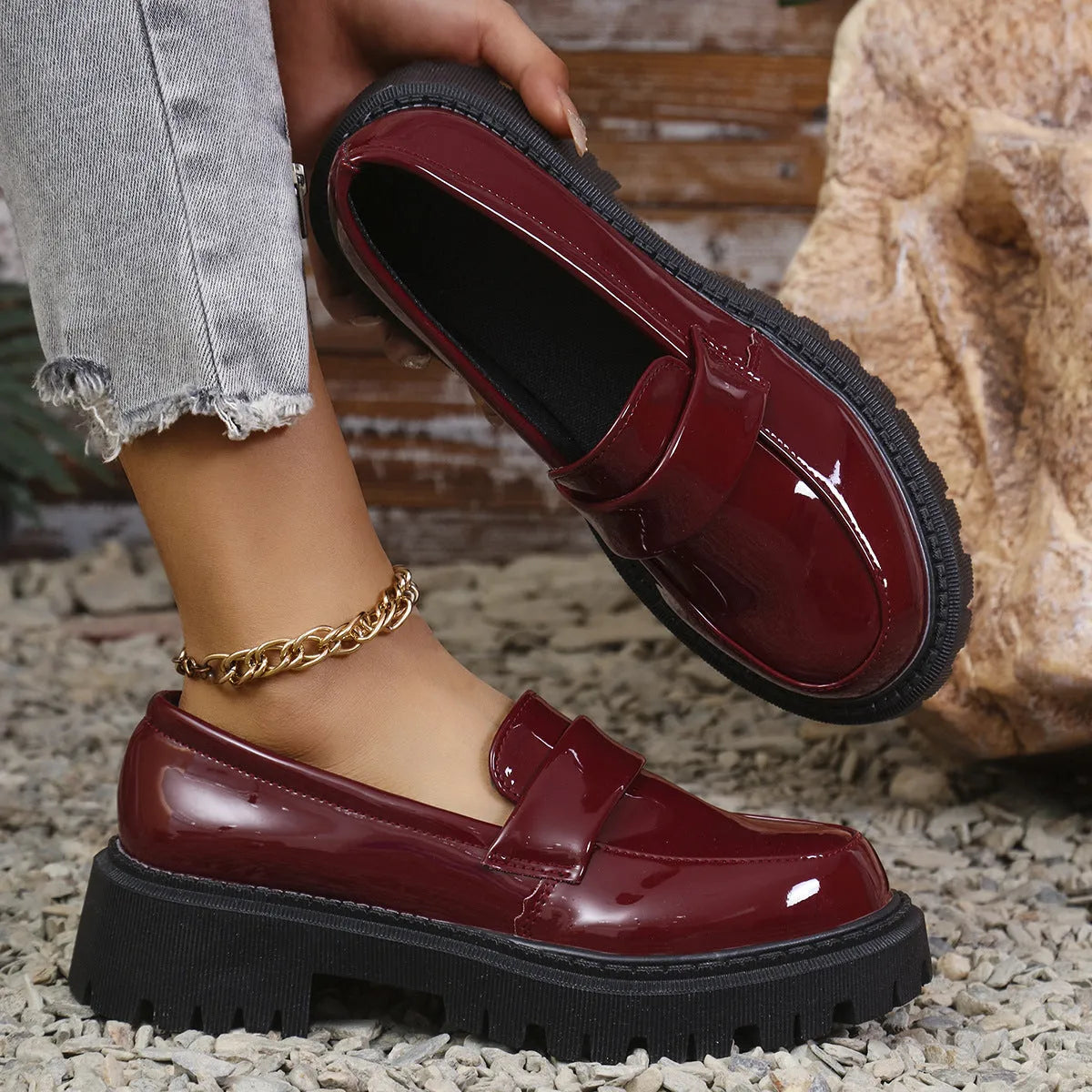 Women's plus size black slip-on loafers with a chunky platform heel and mid-top design.