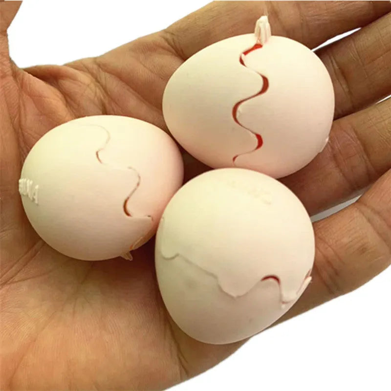 Fake snake egg prank toy with plastic egg shell and stretchable snake on plain background