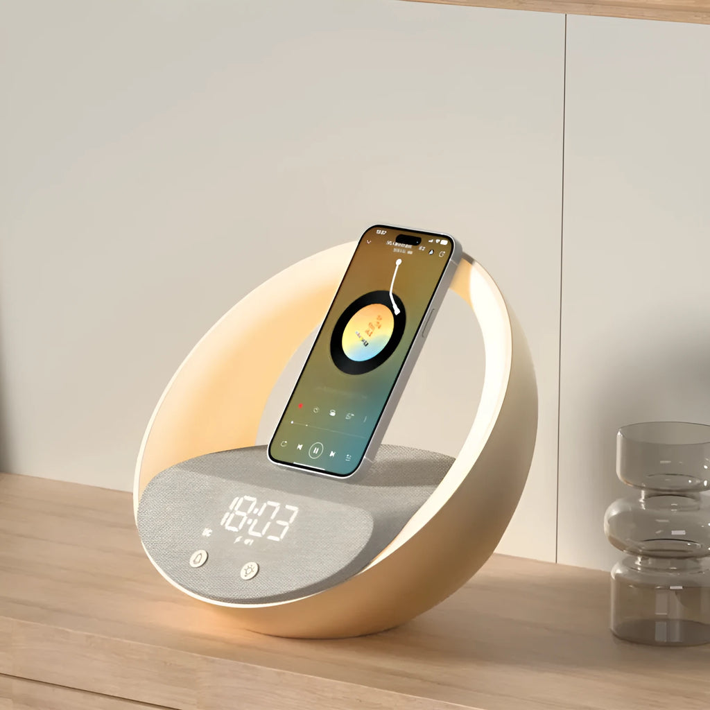 Beige multifunctional Bluetooth speaker with wireless charging pad, LED light, and digital clock display on wooden surface