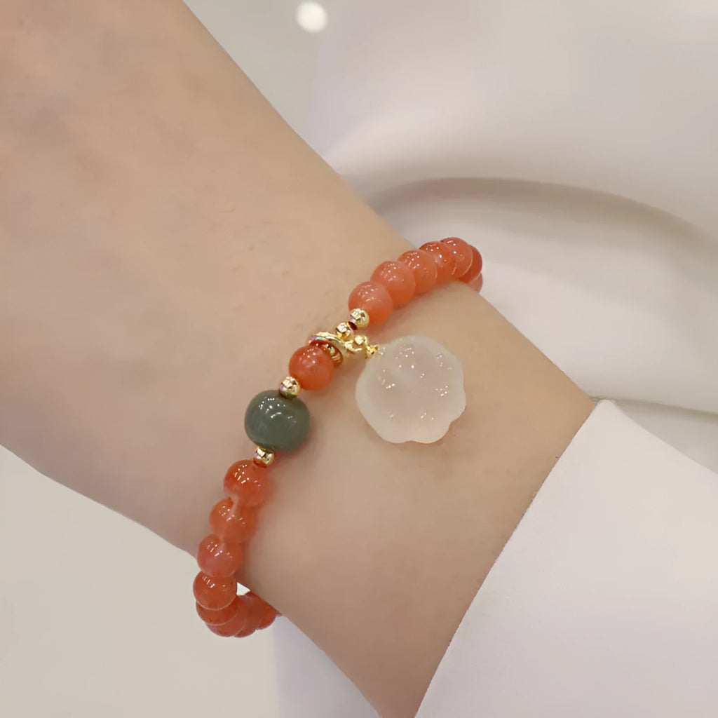 Natural red agate bracelet with jade accents showing 6mm beads and 8mm cat paw zodiac charms