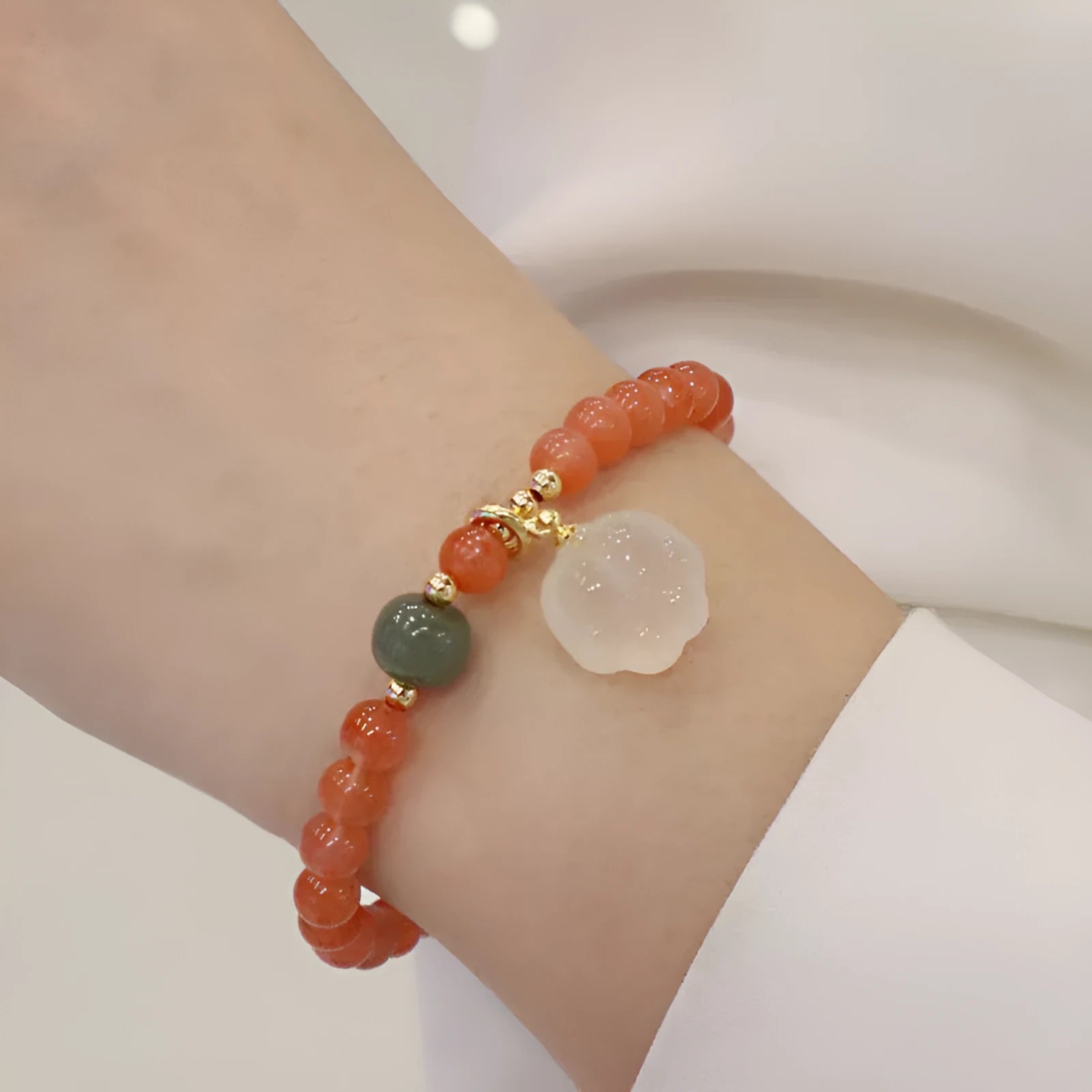 Natural red agate bracelet with jade accents showing 6mm beads and 8mm cat paw zodiac charms