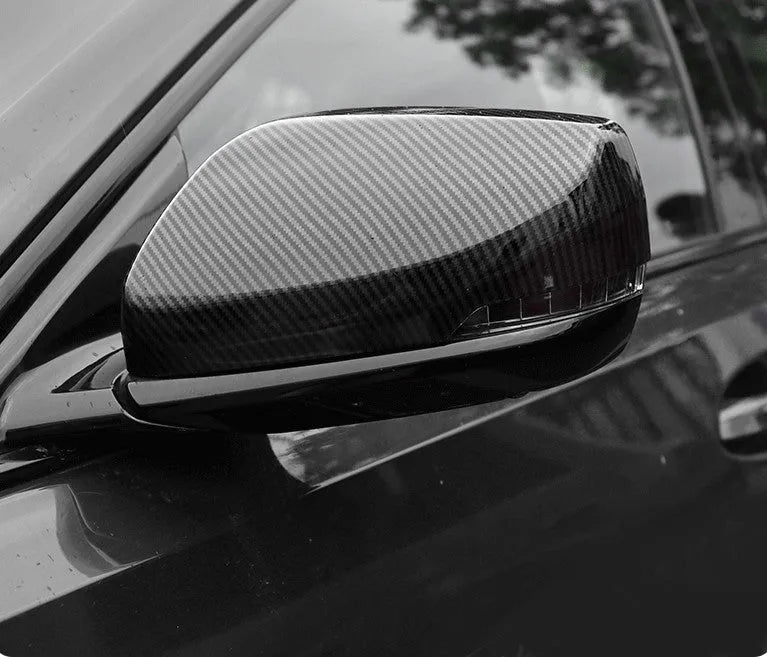 Pair of ABS plastic rearview mirror covers for Cadillac CT5 CT6 in carbon fibre, silver, and rain frame finish options.