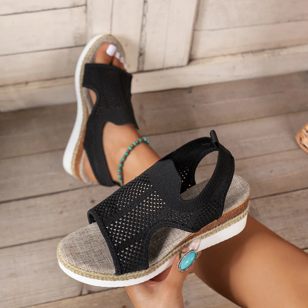 Women's hollow wedge peep-toe sandals in beige with patent leather upper and breathable mesh, side view