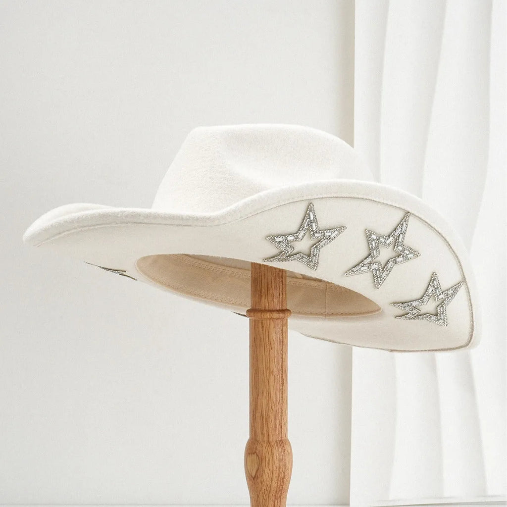 Beige polyester felt western-style top hat with a conical crown and a hexagonal star decoration on the front.