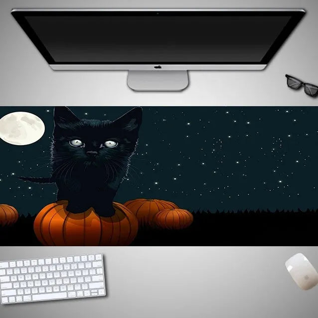 Oversized Halloween pattern rubber cloth mouse pad on a desk with non-slip base.