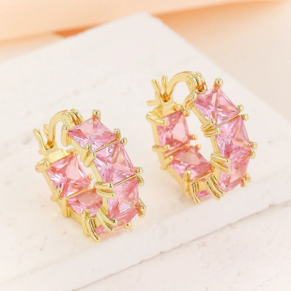 Women's geometric U-shaped earrings with round black zirconium stones and gold electroplated copper construction