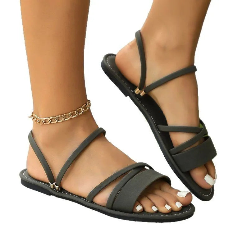 Women's plus size sandals with flip-toe buckle and flat cross-strap in black, brown or green