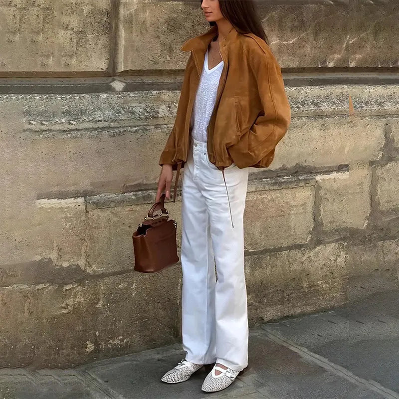 A man wearing a solid-colour loose-fit retro-style long sleeve polyester jacket.