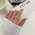 Women's geometric rotating ring with gold electroplated finish and circular decorative elements