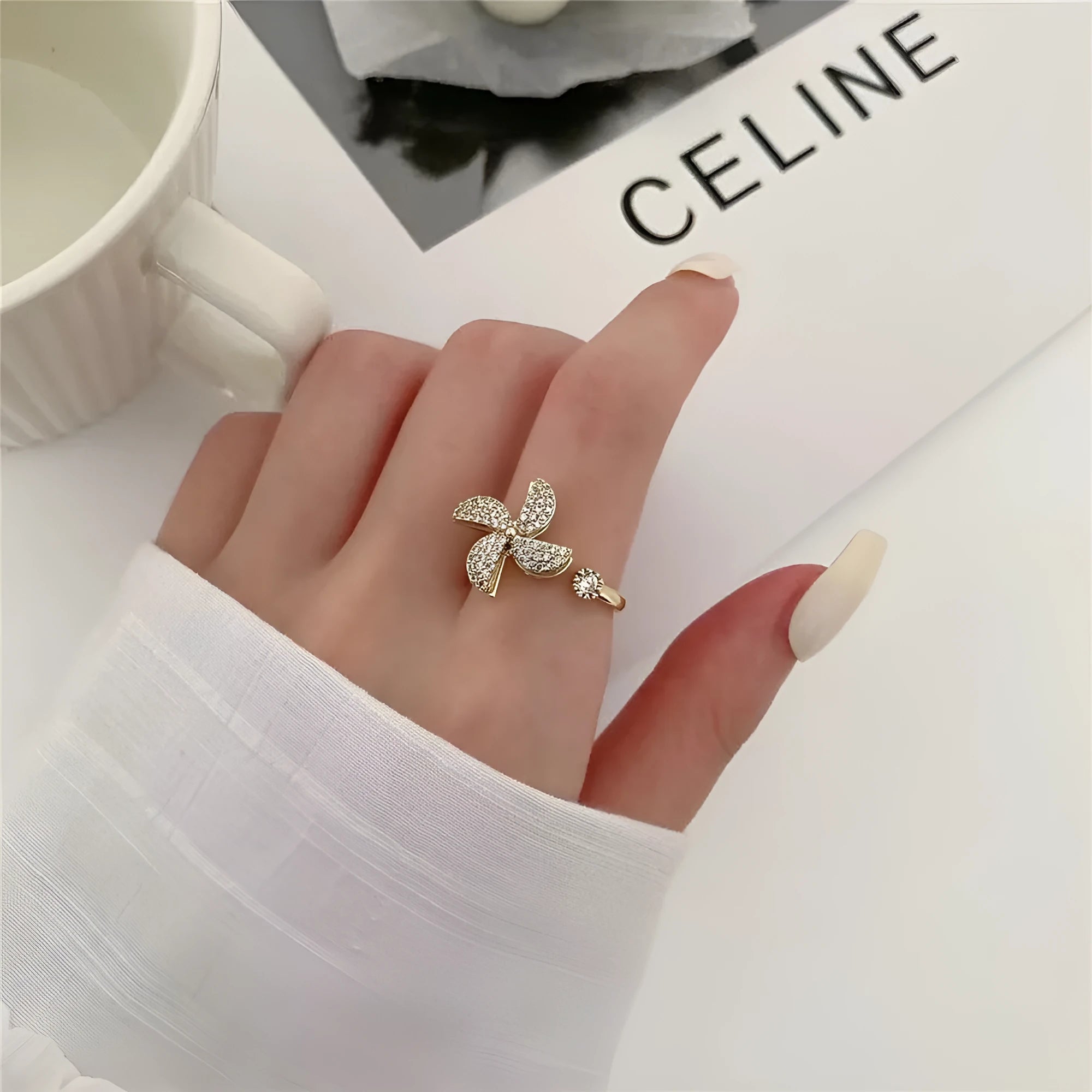 Women's geometric rotating ring with gold electroplated finish and circular decorative elements