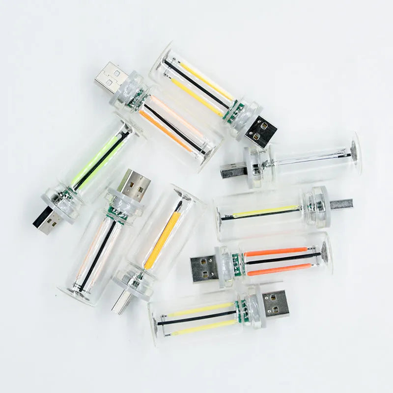 Small transparent glass USB touch night lamp in modern minimalist style.