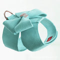 Pink adjustable dog chest strap with a cute bowknot detail, shown on a small puppy.