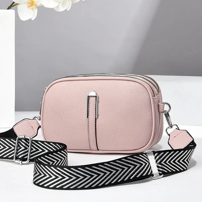Women's soft PU crossbody bag in oval shape with multiple internal compartments and slit pocket