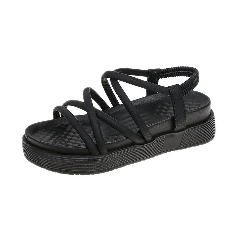 Women's black and beige Roman-style platform sandals with round toe and slip-on design.