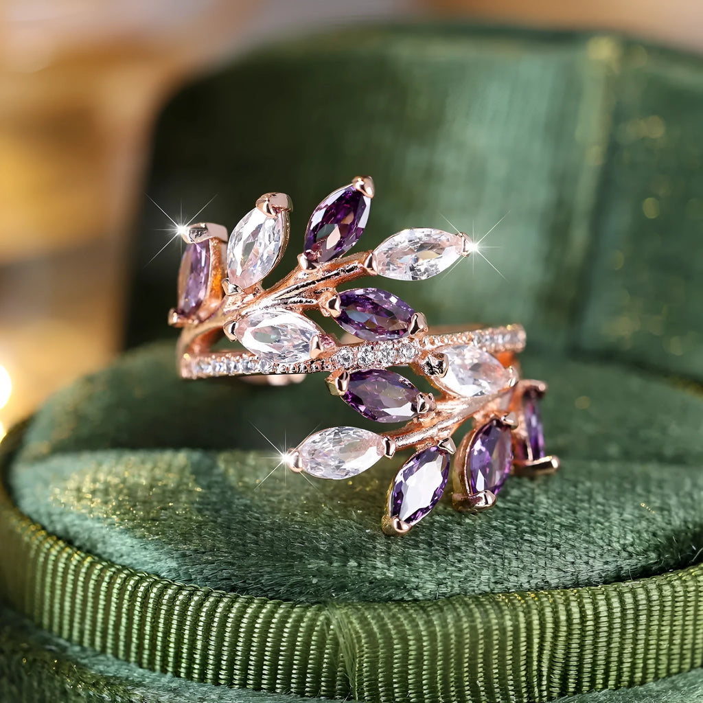 Adjustable copper leaf-shaped ring with zircon stone accents on a hand.