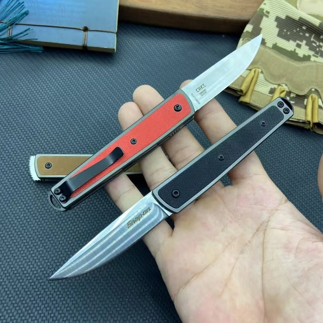CRKT 7190 folding fruit knife with stainless steel blade shown closed and open, in black, brown, or red colour options.