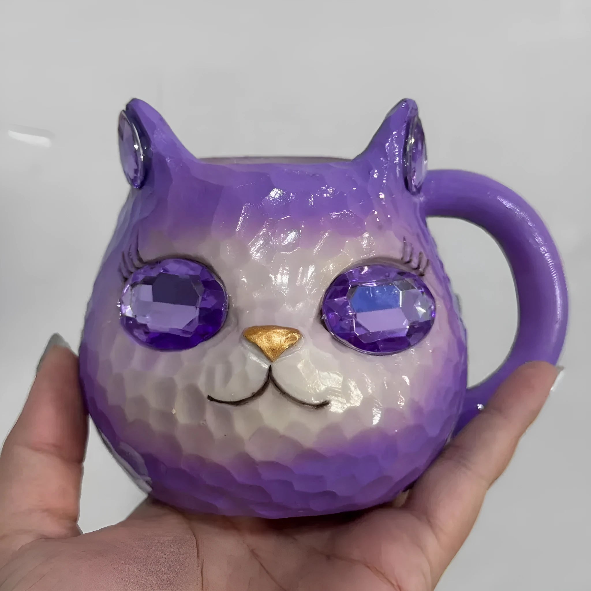 Crystal Earth globe decorative ornament on top of a colourful cat-shaped resin cup.