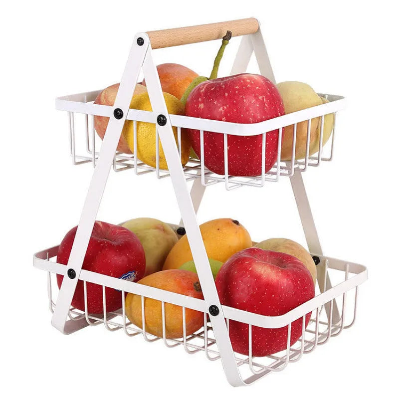 Black detachable iron double-layer fruit basket with a wooden handle on a kitchen counter.