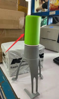 Green or grey Uutensil Stirr automatic pot mixer device for hands-free stirring of sauces and soups.