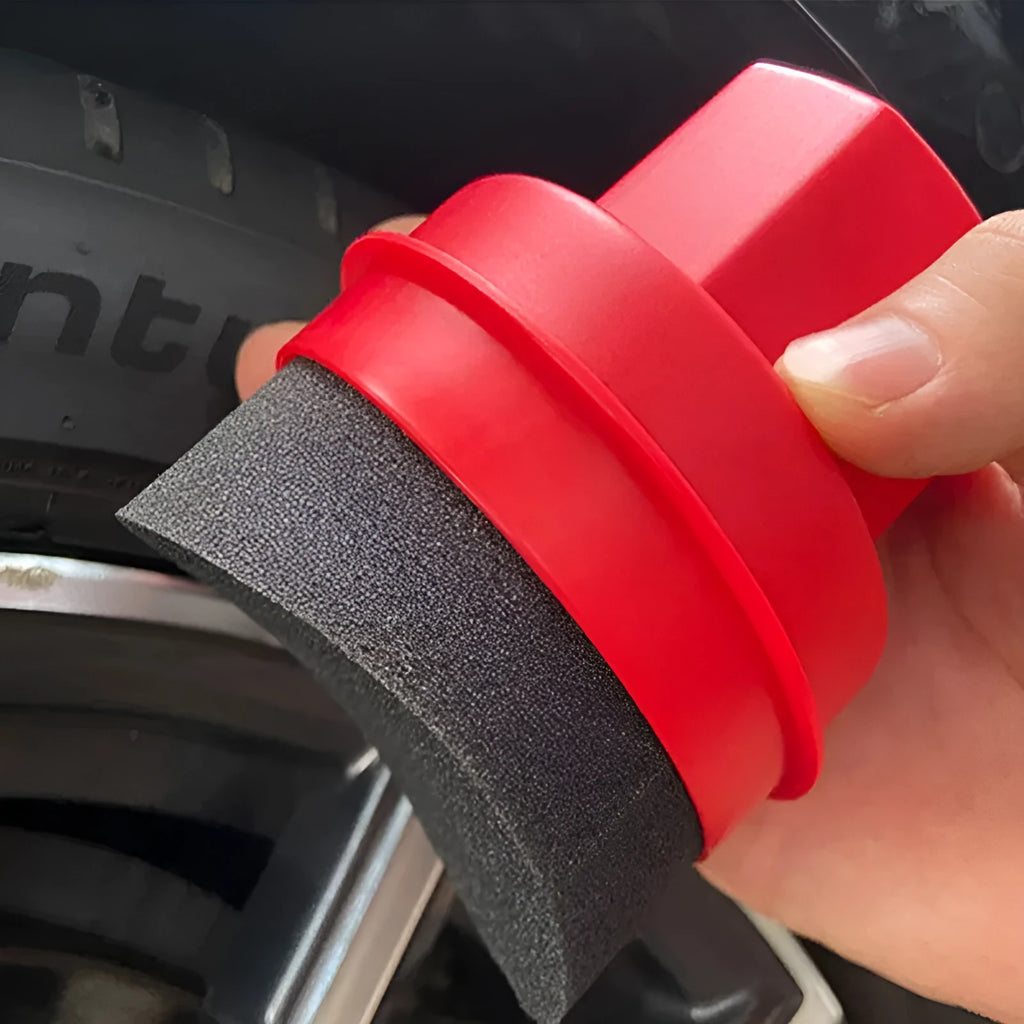 Black and red tyre oil sponge brushes with lids on a white background.