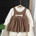 Baby girl wearing a dark coffee plaid long-sleeved dress and matching shirt, Korean style two-piece set.