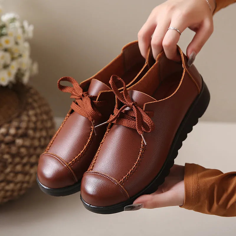 Women's black round toe flat work shoes with front lacing and soft anti-slip polyurethane sole