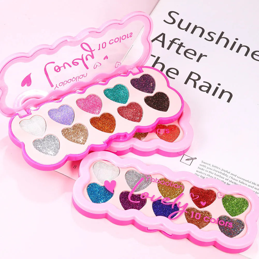 Heart-shaped compact open to show ten pans of pearlescent sequin eyeshadow in various colours.