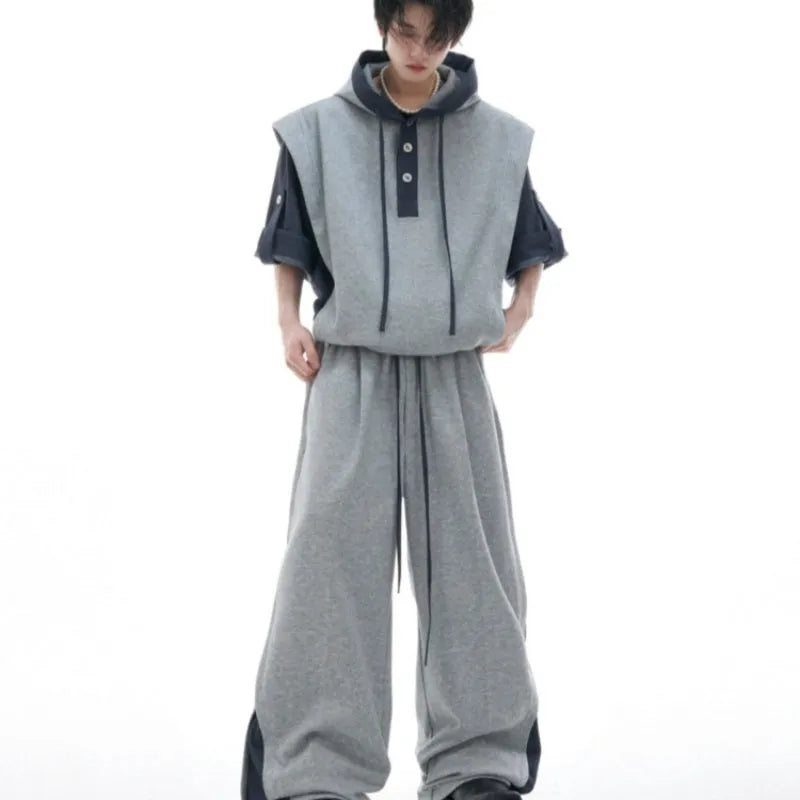 Men's grey hooded sports jacket and matching trousers with three-dimensional stitching detail.