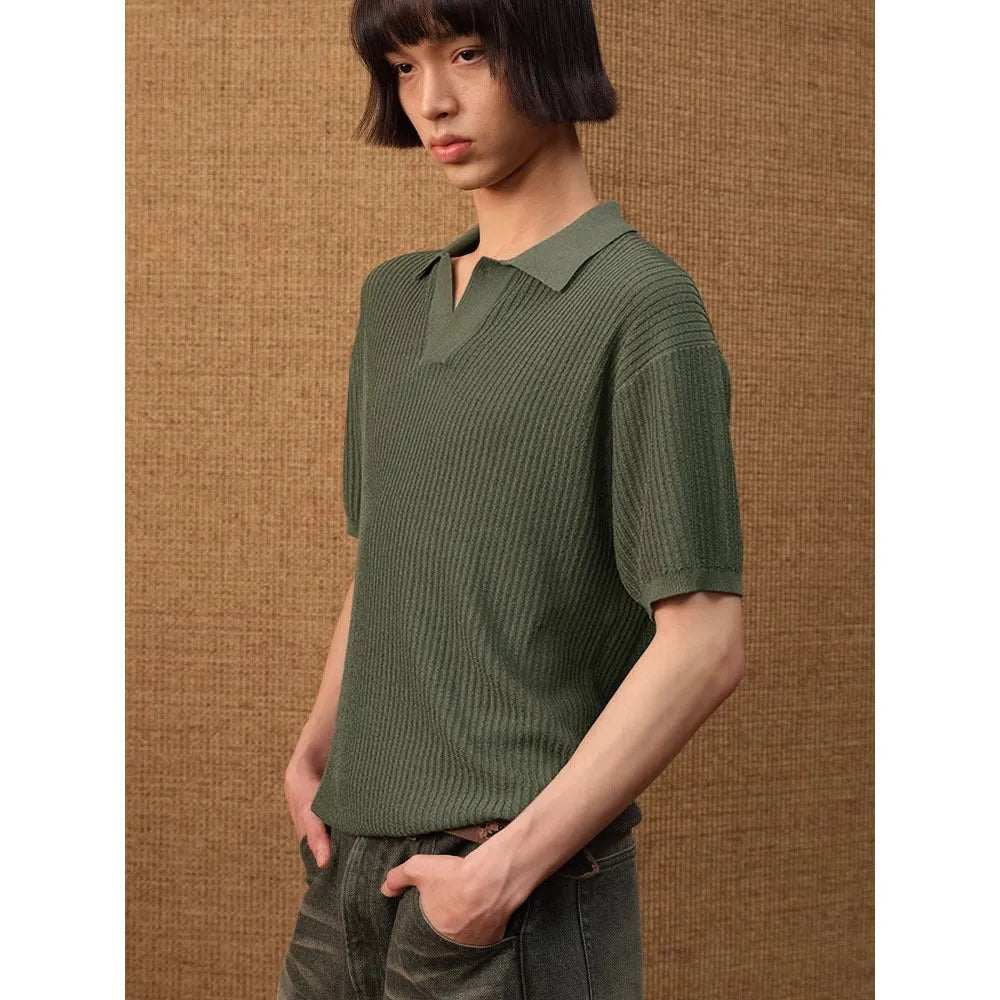 Men's creamy white polo shirt with short sleeves and a loose fit on a hanger.