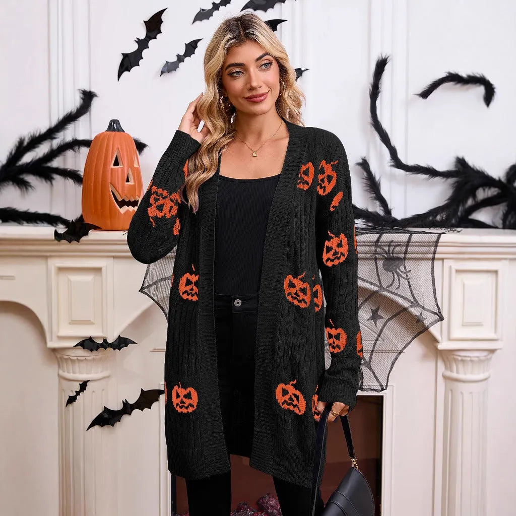 Women's black cardigan with orange pumpkin head jacquard knit pattern on the front.