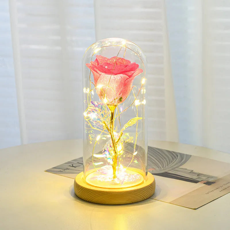 Handmade eternal red rose flower with warm white LED light inside a glass cover
