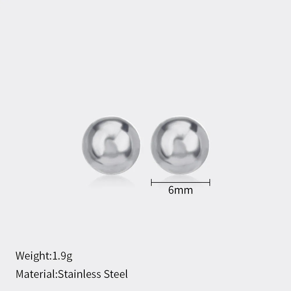 Simple stainless steel stud earrings with geometric sphere design in gold colour on white background