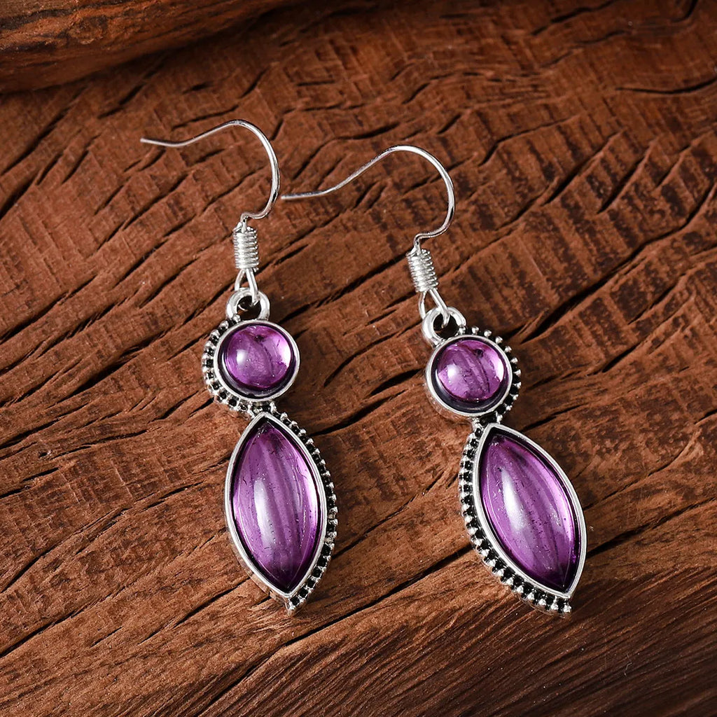A pair of vintage-style geometric earrings with a black and purple electroplated finish on a zinc alloy base.