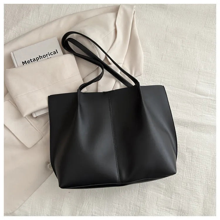 Black PU leather bucket messenger bag with stitching and open outer pocket, double straps, medium hardness