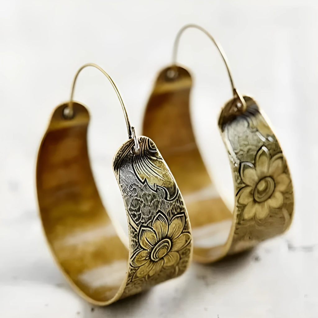 Gold coloured women's earrings with an intricate hollow petal design in a geometric Maillard style.
