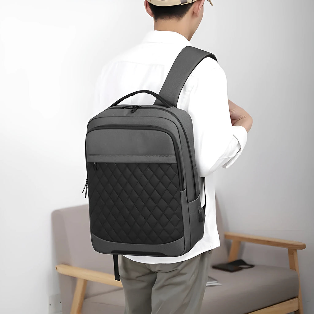 Men's black leisure travel backpack with diamond mesh detail and curved shoulder straps