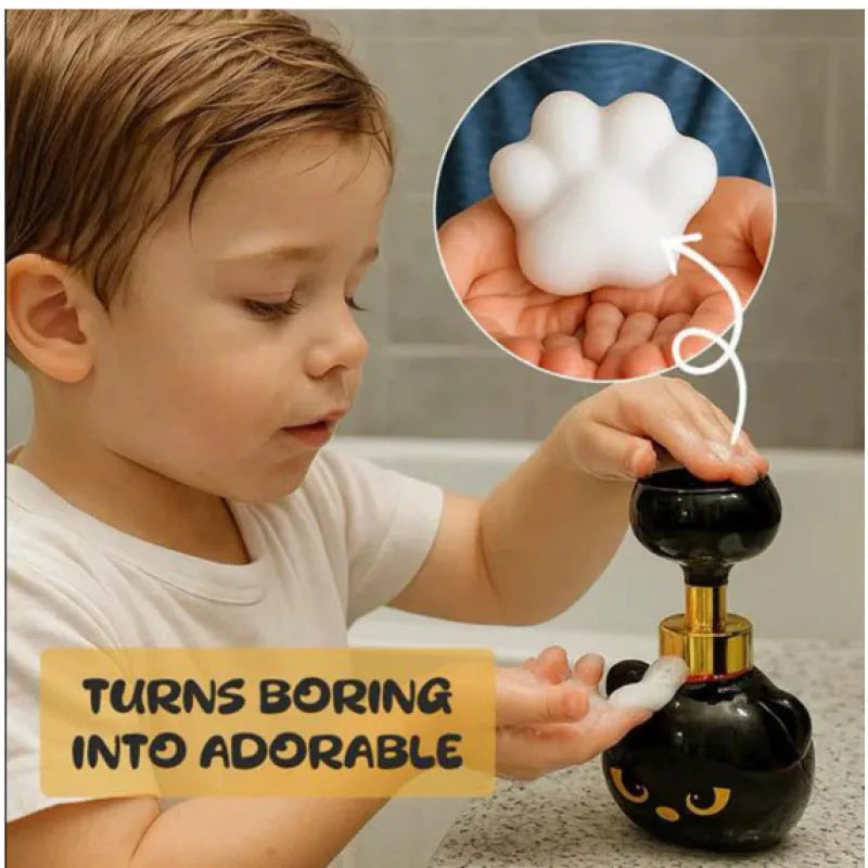 Black cartoon cat-shaped plastic foam soap dispenser on a wash basin.