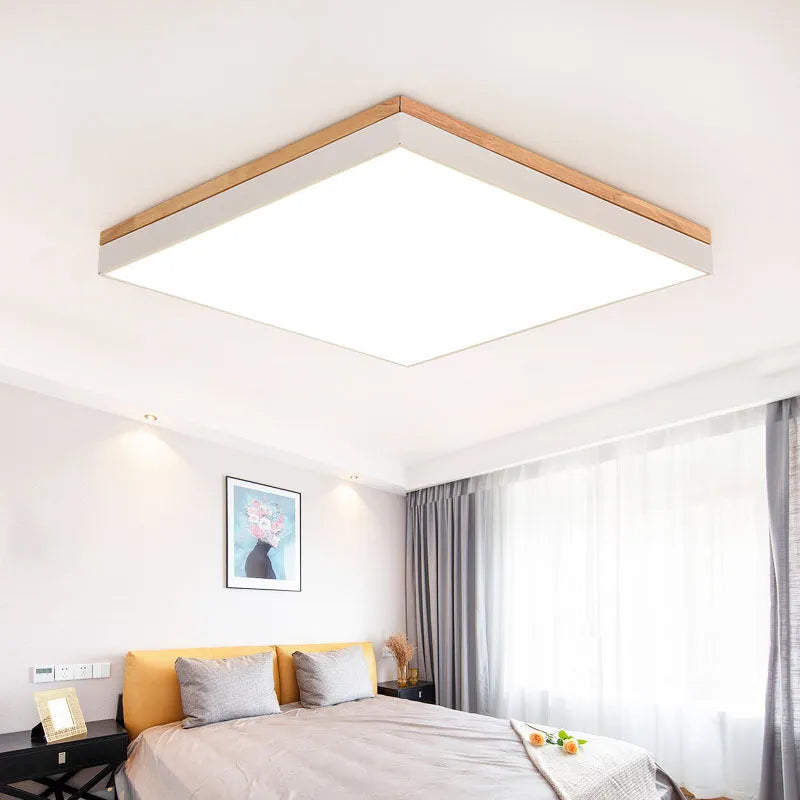 Round Nordic style wooden and iron LED ceiling lamp on a white ceiling.