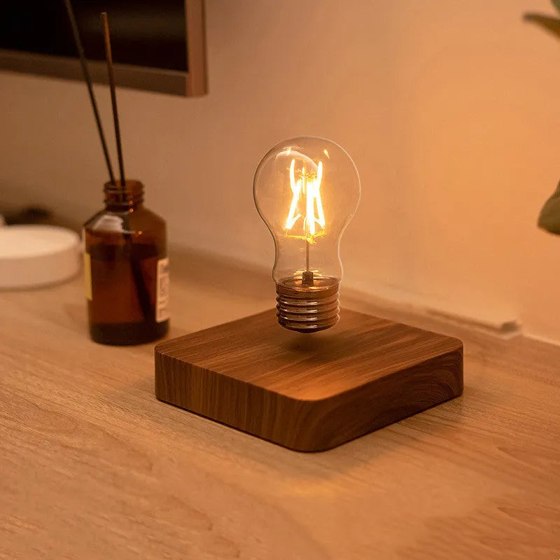 Self-rotating maglev bulb with warm yellow light, ABS base, 6cm diameter bulb, and 13.5cm diameter base.